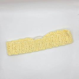 Handmade yellow crochet headband on white background, cozy crochet gift by Erika Liesel