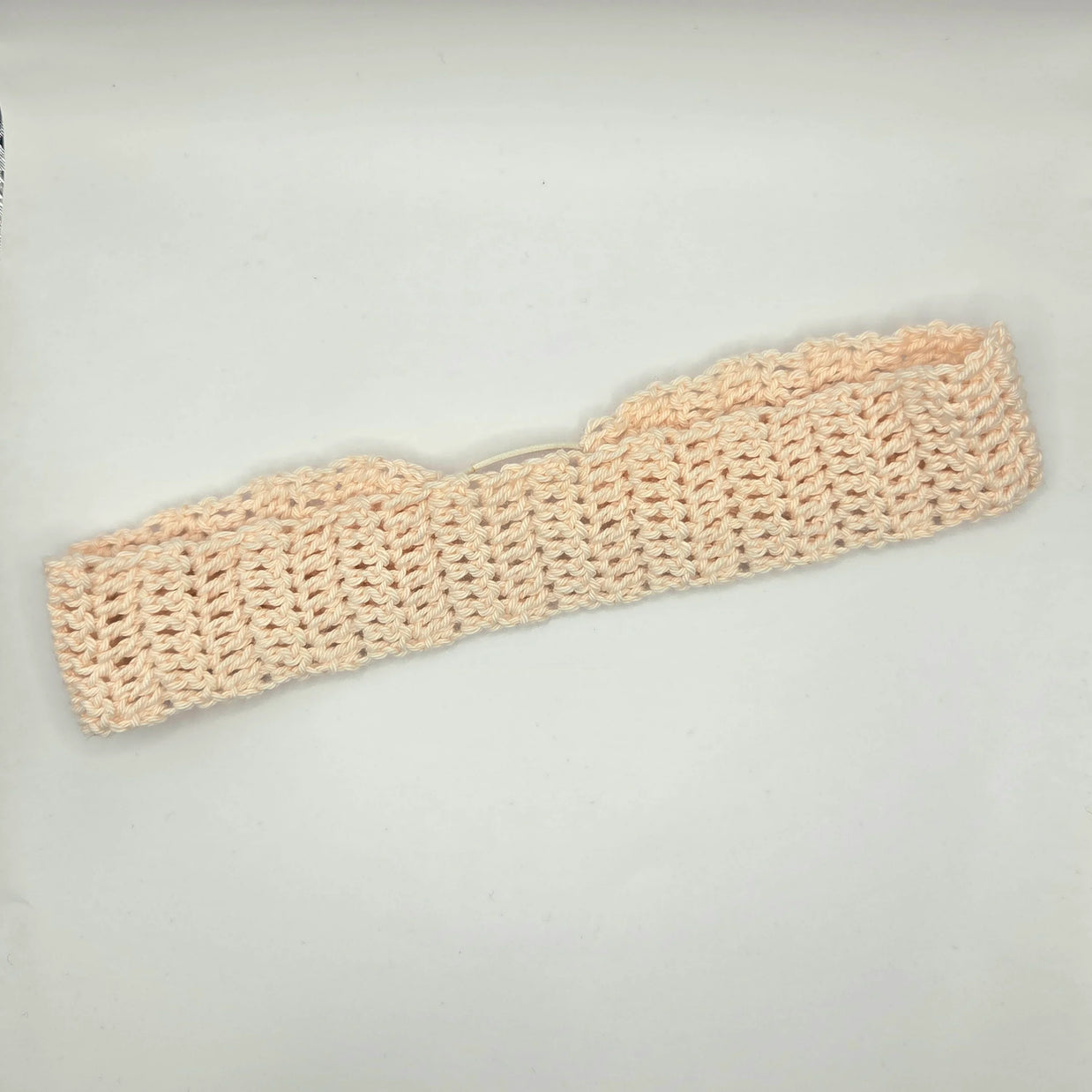 Handmade crochet headband in soft beige yarn, cozy and crafted by Erika Liesel