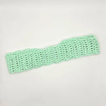 Mint green crochet headband, handmade with cozy open stitch pattern for comfort and style