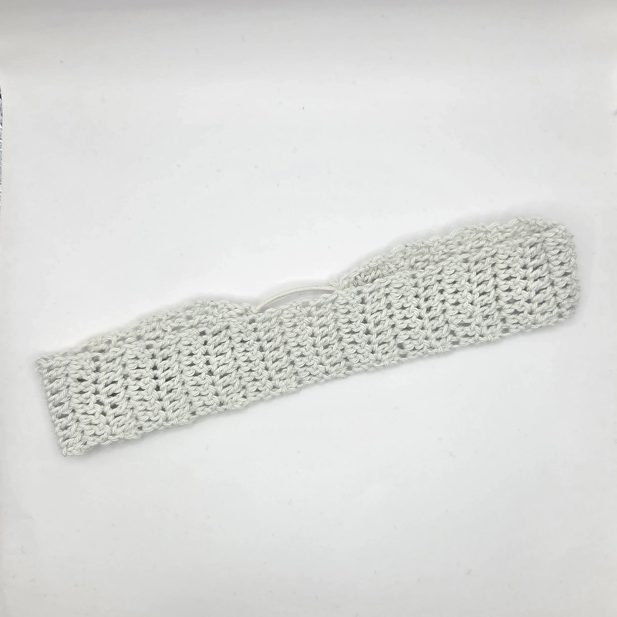 Knitted headband on a light gray background