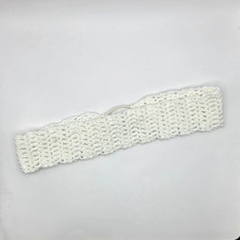 Handmade white crochet headband on plain background, cozy crochet gift by Erika Liesel