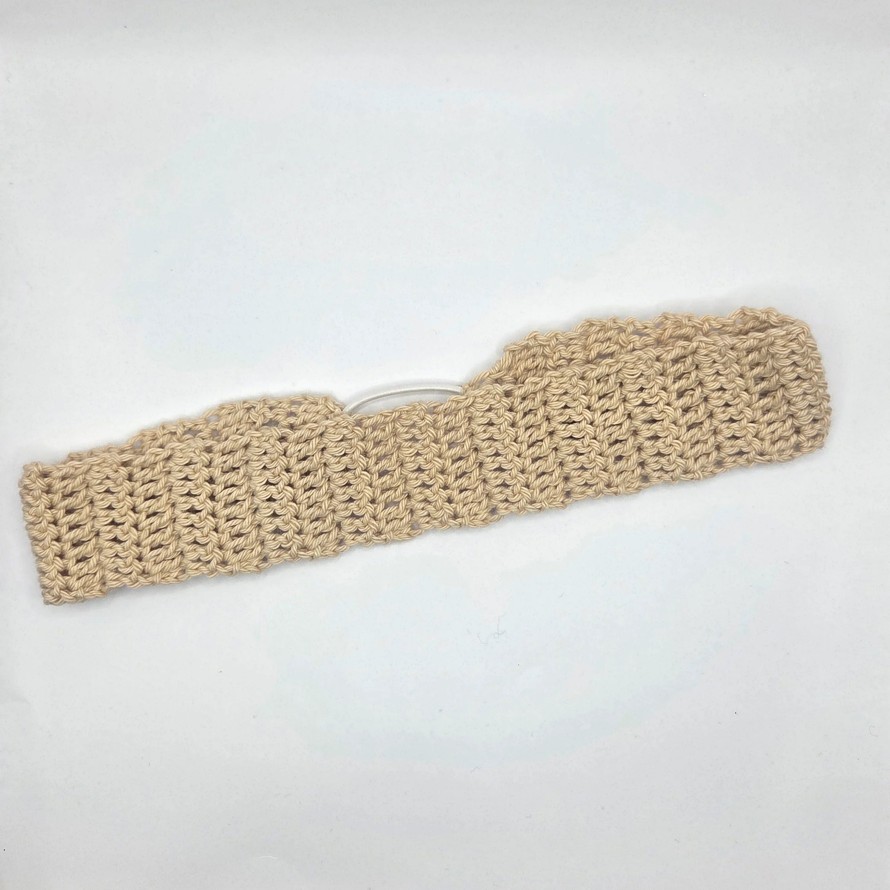 Handmade beige crochet headband on white background, cozy gift by Erika Liesel