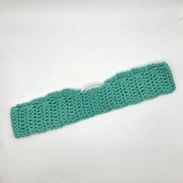 Green knitted headband on a white background
