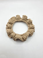 Handmade crochet scrunchie in neutral beige, perfect for cozy everyday style and thoughtful gifting.