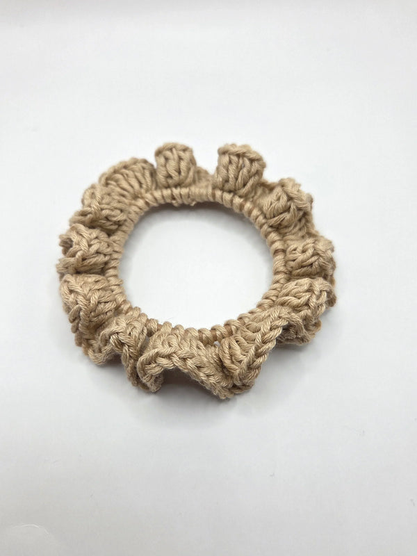 Handmade crochet hair scrunchie in neutral beige, soft textured yarn, cozy boho accessory