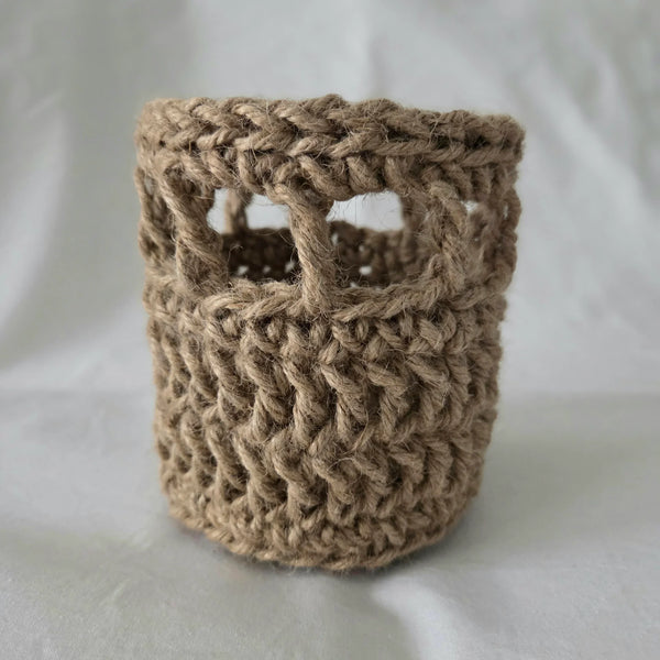 Handmade crochet basket with open weave design, cozy rustic storage for home decor or gifts