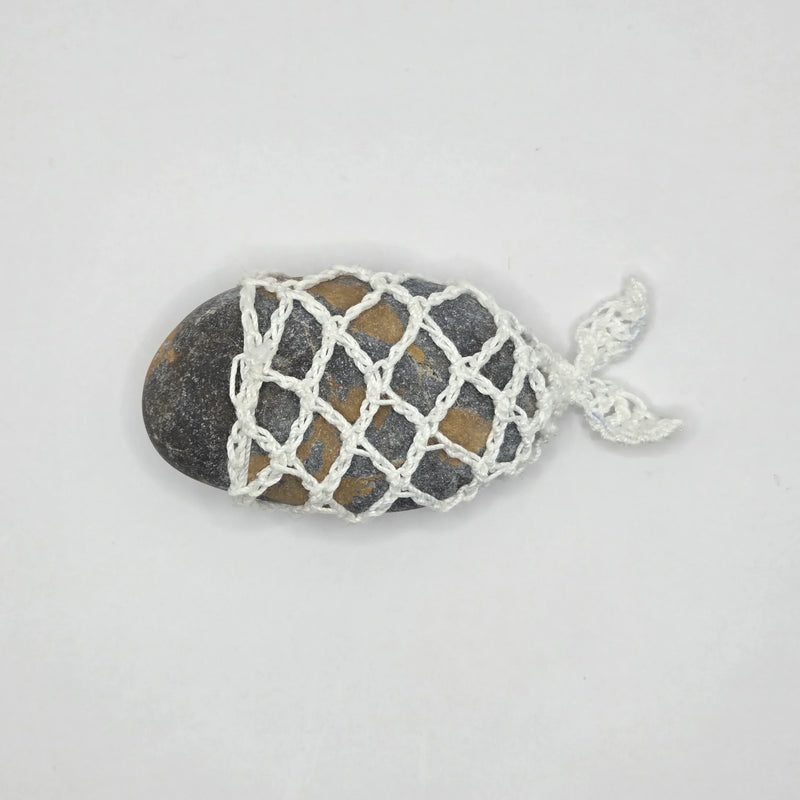 Handmade crochet fish netting over smooth river stone, cozy home decor gift