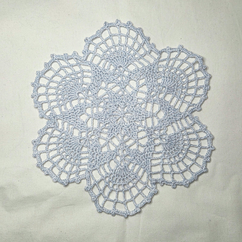 Handmade crochet doily with intricate lace pattern, perfect for cozy home decor or thoughtful gift