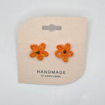 Handmade crochet flower earrings in orange and yellow, perfect for cozy, creative gifts.