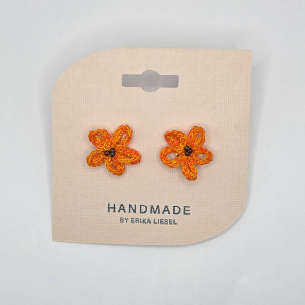 Handmade crochet flower earrings in orange and yellow, perfect for cozy, creative gifts.