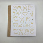 Gold foil baby icons on white card with rhinestones, perfect for baby shower or newborn gift
