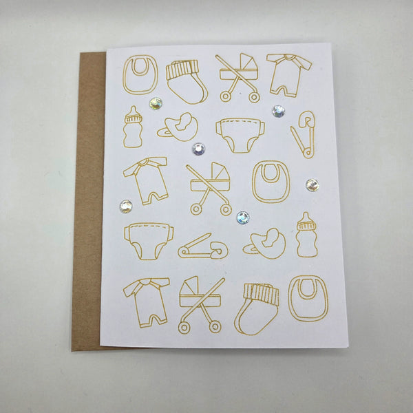 Gold foil baby icons on white card with rhinestones, perfect for baby shower or newborn gift