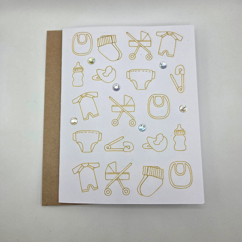 Gold foil baby icons on white card with rhinestones, perfect for baby shower or newborn gift