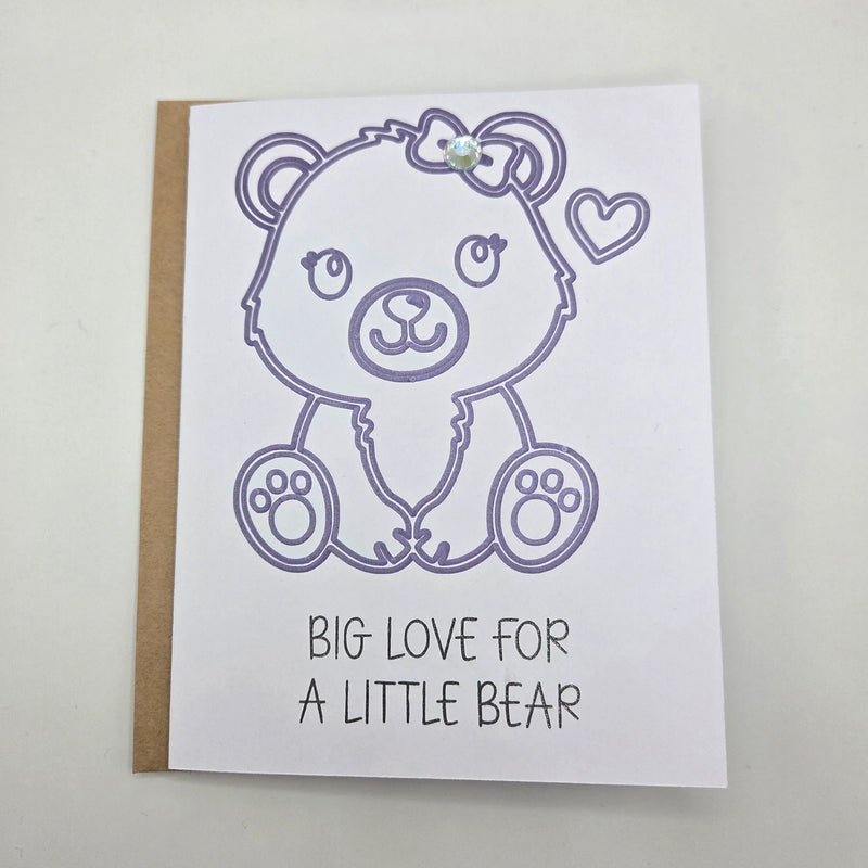 Handmade bear card with purple outline, bow, heart, and gem, saying 'Big Love for a Little Bear'
