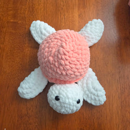 Handmade crochet bunny with pink body and white ears, perfect for cozy gifts