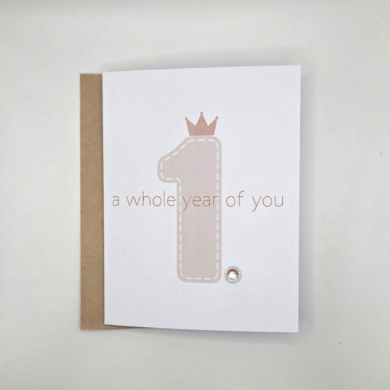First birthday card with crown number one and 'a whole year of you' text