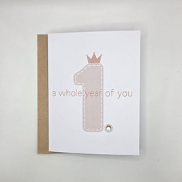 First birthday card with crown number one and 'a whole year of you' text