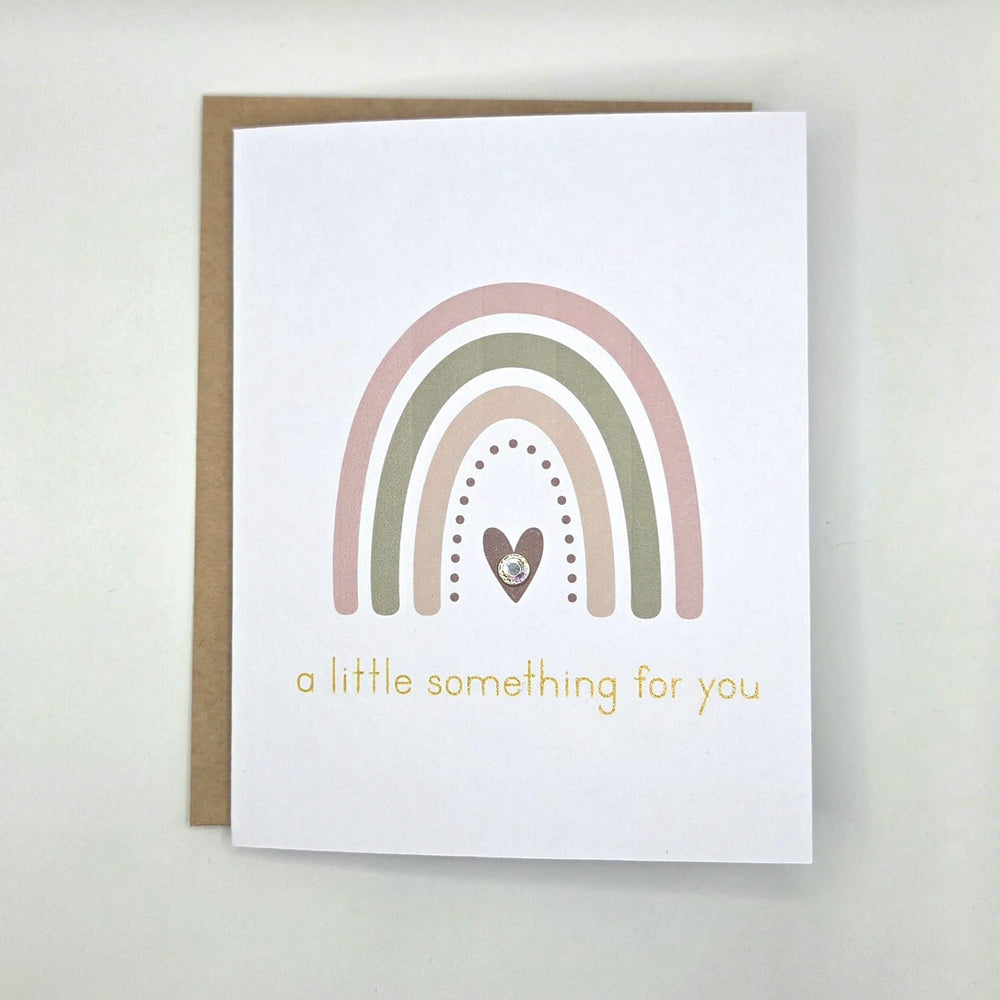 Boho rainbow greeting card with heart and gold text 'a little something for you'