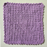 Handmade lavender crochet dishcloth with scalloped edges, cozy kitchen textile