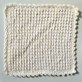 Handmade crochet dishcloth with scalloped edges, cozy and textured for kitchen use