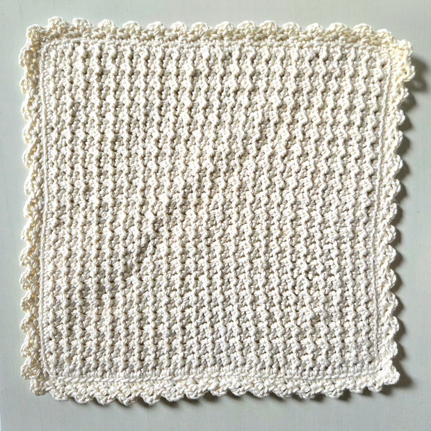 Handmade crochet dishcloth with scalloped edges, cozy and textured for kitchen use