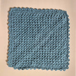 Handmade blue crochet dishcloth with scalloped edge, cozy kitchen textile