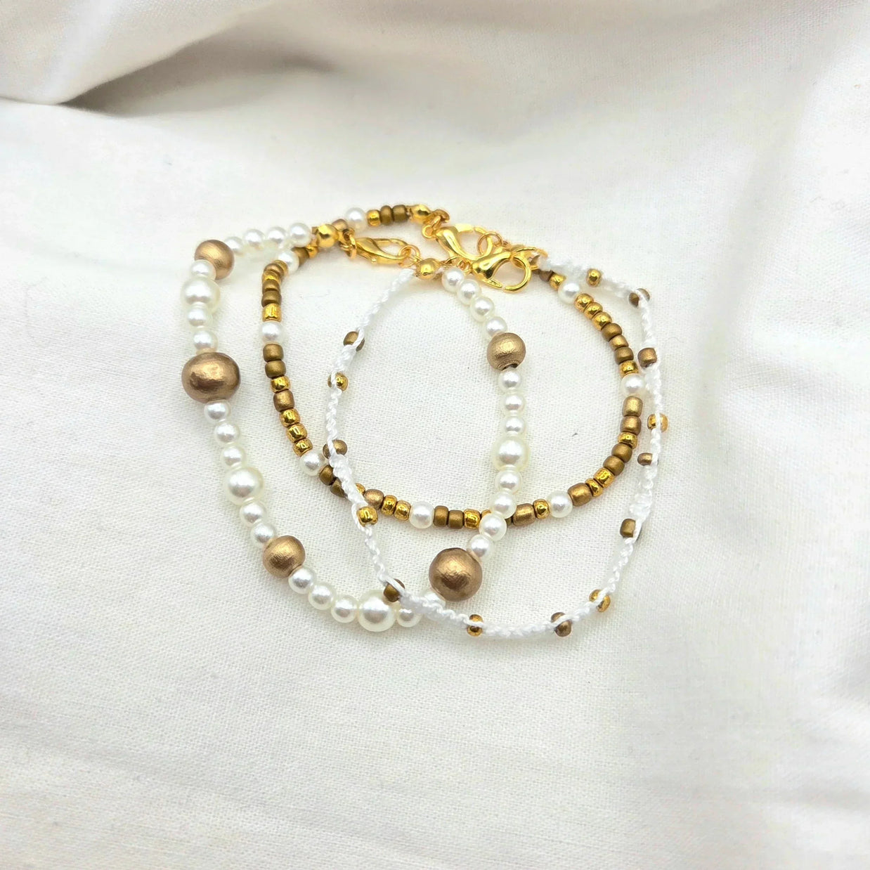 Handmade pearl and gold bead necklace with white cord, elegant and cozy accessory for everyday wear