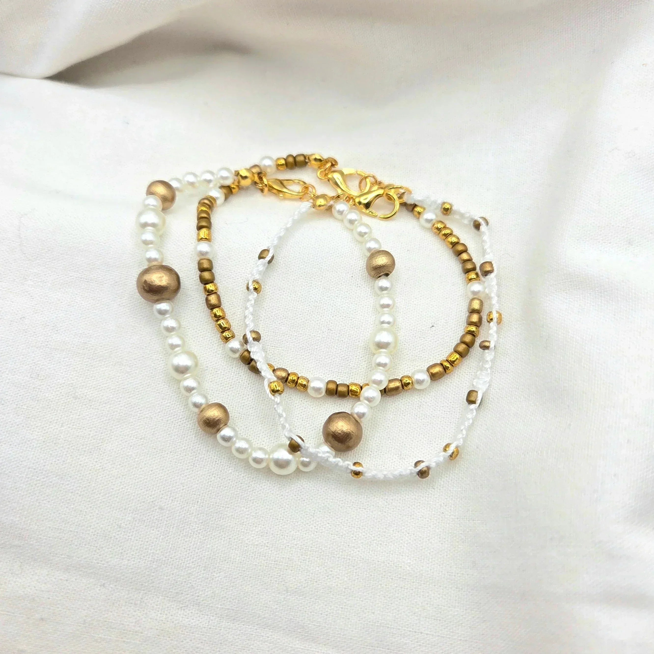 Handmade pearl and gold bead necklace with white cord, elegant and cozy accessory for everyday wear