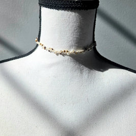 Handmade beaded choker necklace with pearls and gold beads, displayed on mannequin