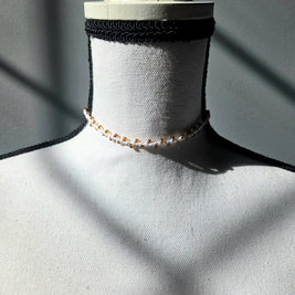 Handmade crochet choker necklace with amber beads, displayed on mannequin neck for cozy, creative style.