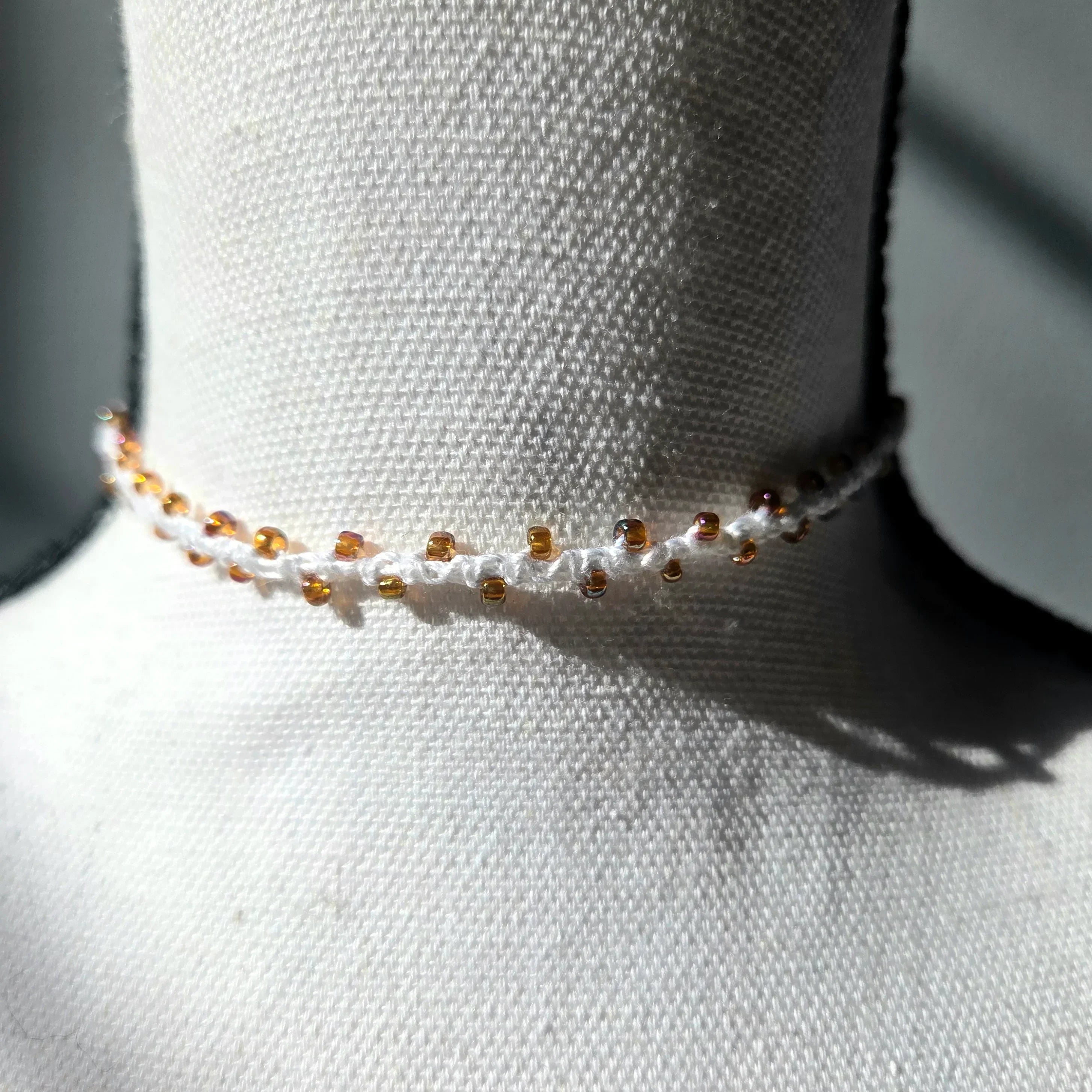 Handmade crochet choker necklace with amber beads, cozy and delicate accessory for everyday wear.