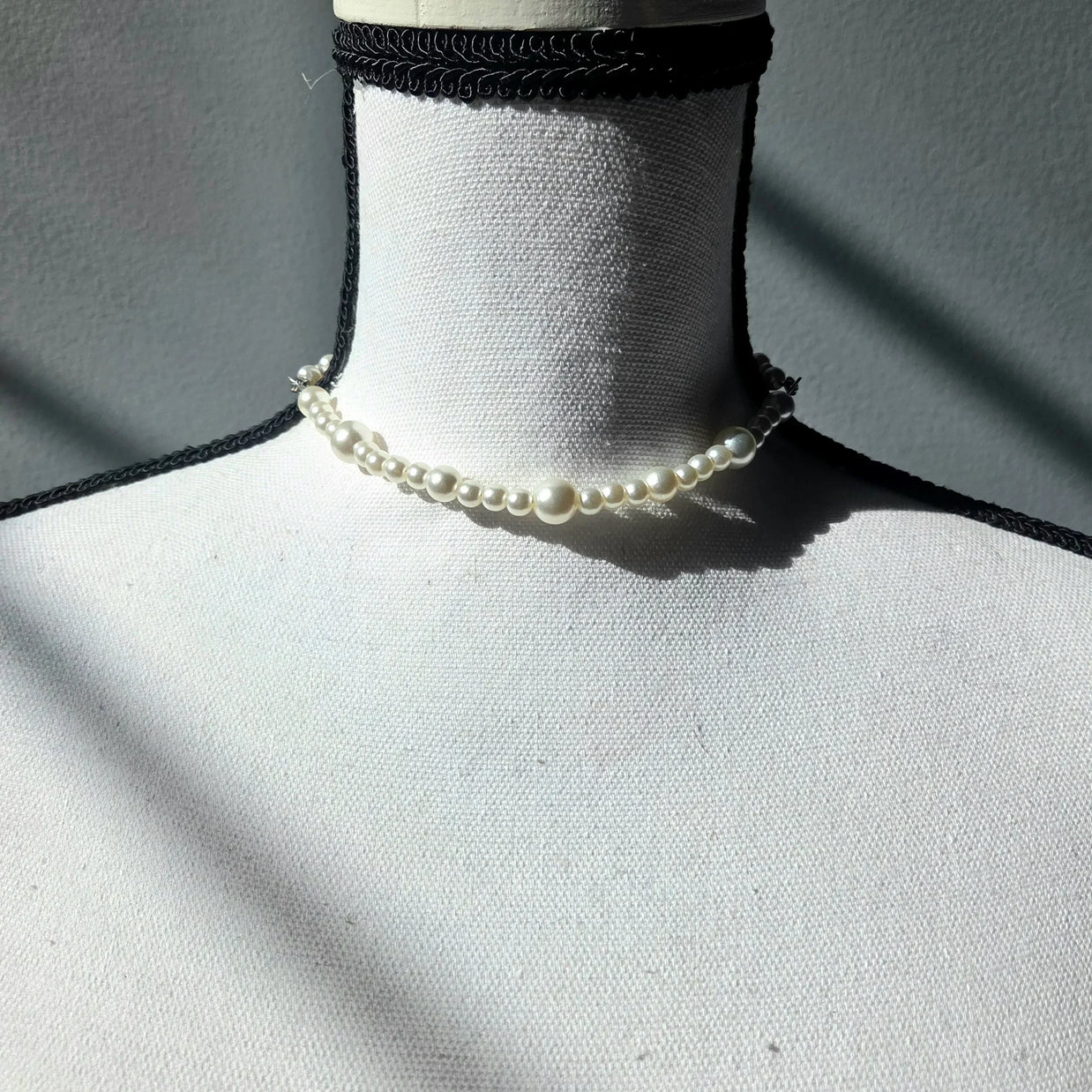 Elegant pearl choker necklace on mannequin, delicate handmade jewelry for everyday wear