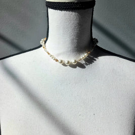 Delicate pearl necklace with gold chain on white mannequin, elegant handmade jewelry for everyday wear