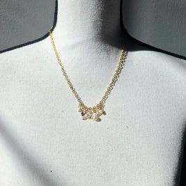 Delicate gold chain necklace with pearl and bead cluster pendant, perfect for cozy everyday wear.