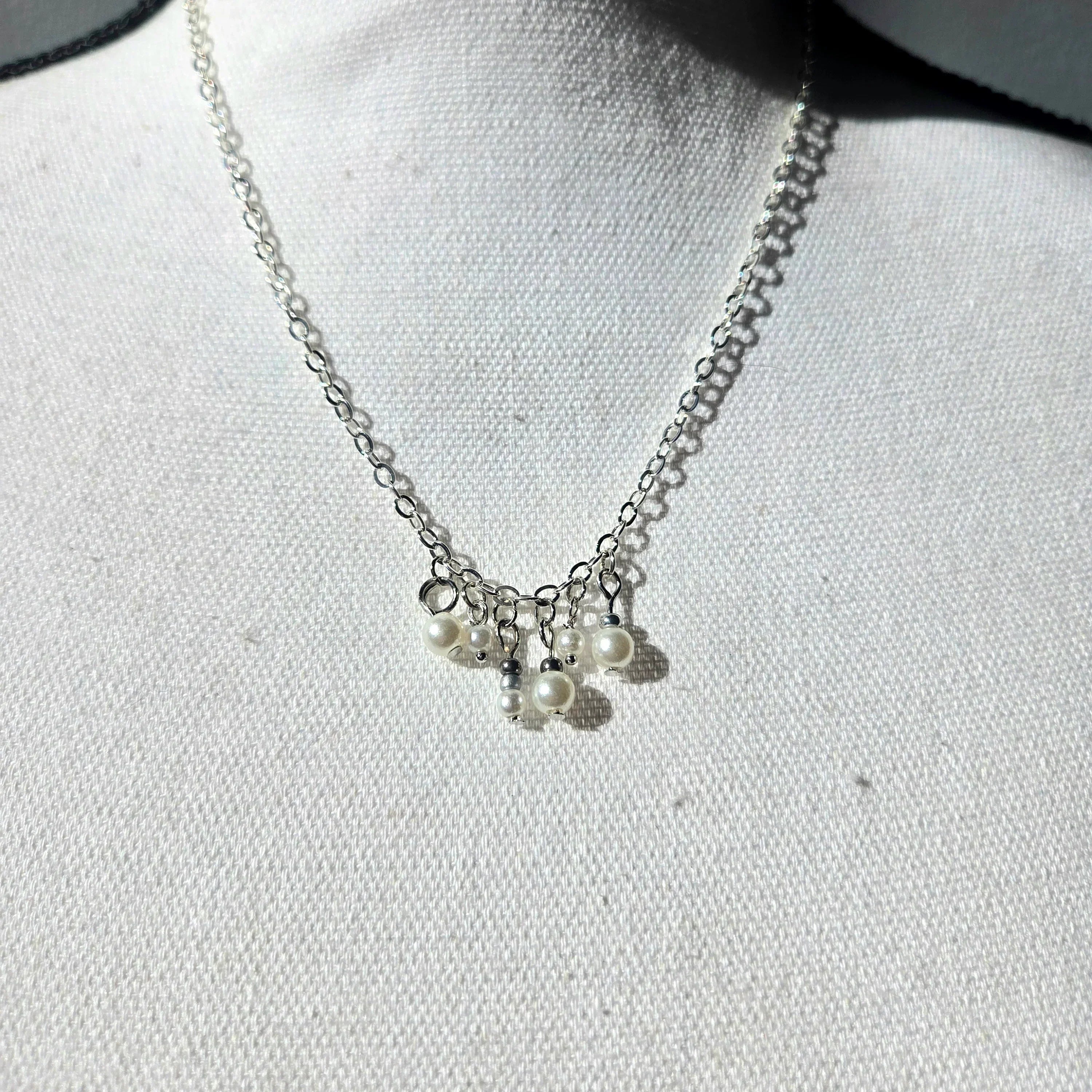 Delicate silver chain necklace with dangling pearl charms, perfect for everyday elegance and thoughtful gifting.