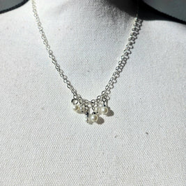 Delicate silver chain necklace with dangling pearl charms, perfect for everyday elegance and thoughtful gifting.