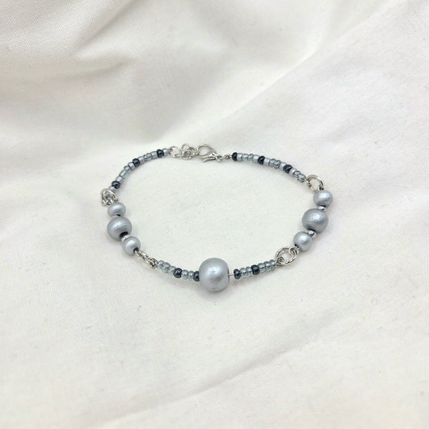 Handmade gray beaded bracelet with silver accents, perfect for cozy everyday wear
