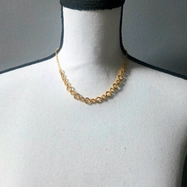 Gold circle link necklace on white mannequin, delicate chain jewelry for everyday wear