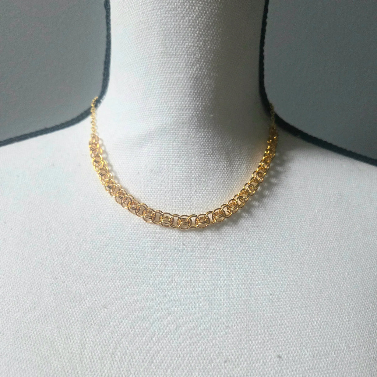 Gold chain necklace on white display bust, elegant everyday jewelry piece