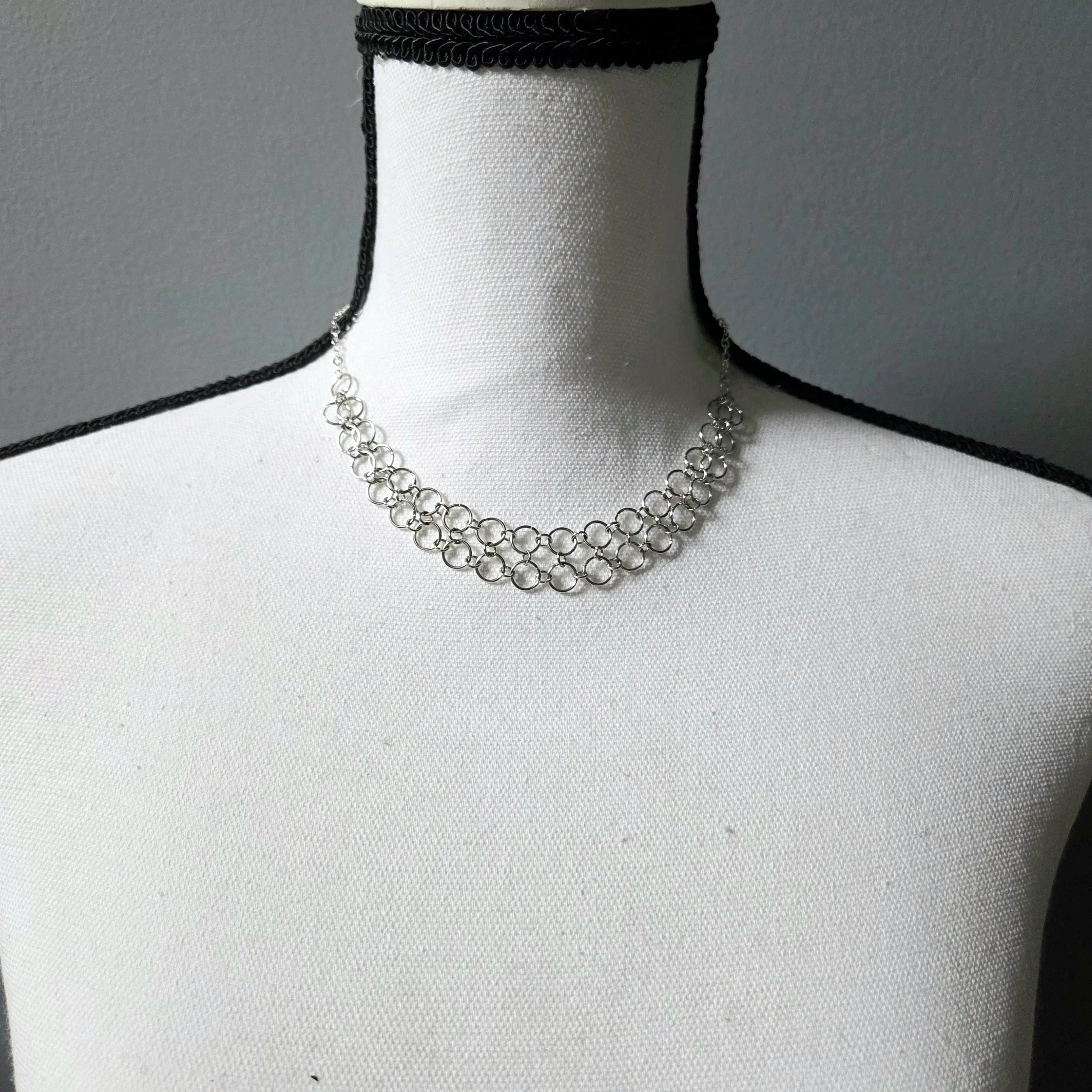 Silver chainmaille choker necklace on white mannequin, delicate handmade jewelry for everyday wear