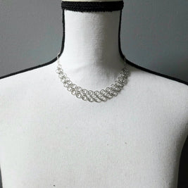 Silver chainmaille choker necklace on white mannequin, delicate handmade jewelry for everyday wear