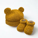 Handmade mustard crochet baby hat with bear ears and matching booties, cozy newborn set