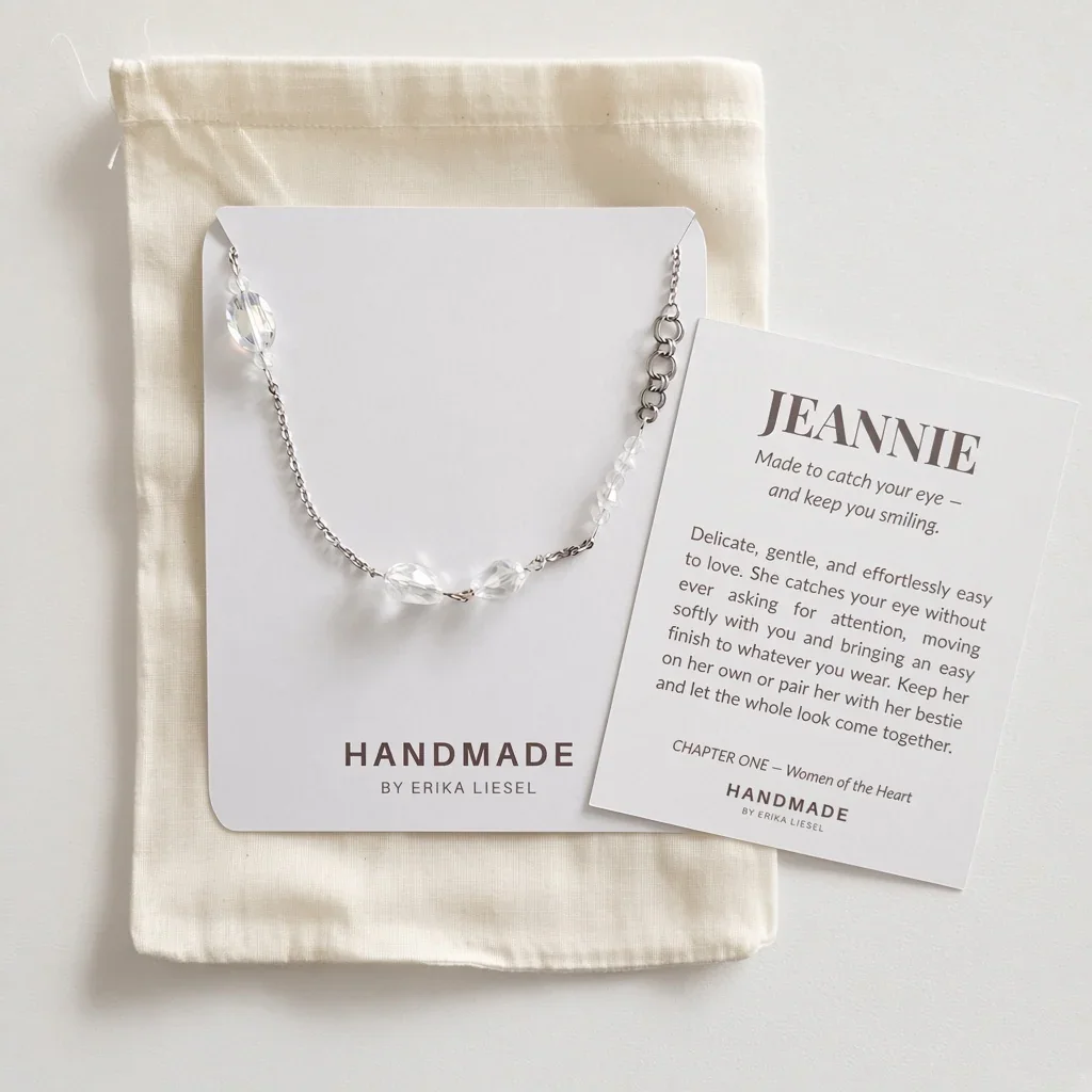 A silver chain bracelet with clear faceted beads, presented on a white card next to a personalized card reading 'JEANNIE' and tucked into a cream drawstring pouch branded HANDMADE BY ERIKA LIESEL.