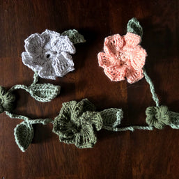 crocheted flowers on a vine garland