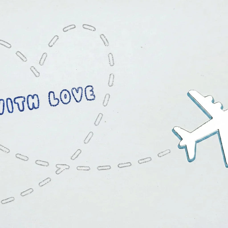 Handmade by Erika Liesel With Love greeting card featuring a shiny silver airplane and a dashed heart flight path.