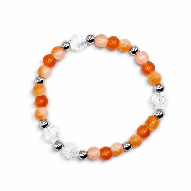 Handmade by Erika Liesel stretch bracelet featuring apricot orange glass beads, clear crystals, and silver accents.