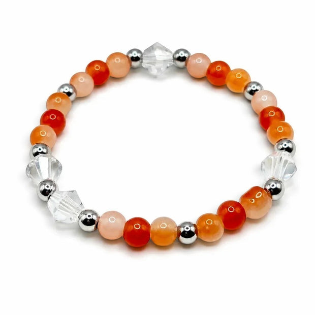 Handmade by Erika Liesel apricot stretch bracelet featuring orange glass beads, clear crystals, and silver accents.