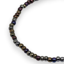 Handmade by Erika Liesel Aurora stretch bracelet with iridescent bronze, purple, blue, and green 3mm glass beads.