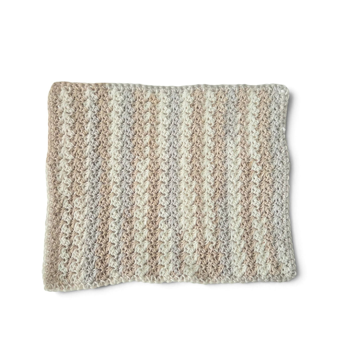 Handmade by Erika Liesel beige crocheted cotton placemat with a textured striped pattern on a white background.