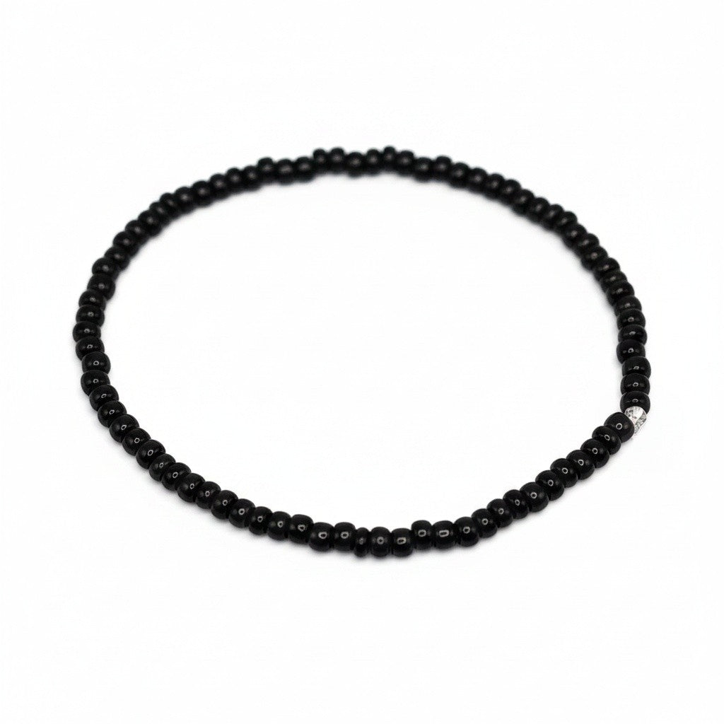 Handmade by Erika Liesel minimalist stretch bracelet featuring glossy 3mm black glass beads on a durable elastic cord.